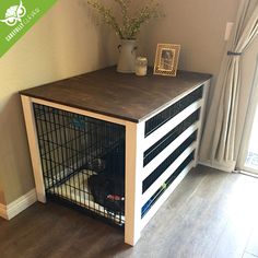 a dog crate sitting on top of a hard wood floor