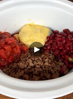 a white bowl filled with food on top of a wooden table