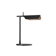 a desk lamp with a black base and a wooden shade on the top, against a white background