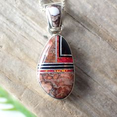 This stunning sterling silver set is created and stamped by Navajo artist Sheryl Martinez. It features an inlay design of Wild Horse, Jet & Opal. The earrings measure 1.2" long including the ear wire by 0.4" wide. The pendant measures 1.3" long (from the top of the bail) by 0.5" wide.Pictured on a 1 mm chain which is sold separately here. Southwestern Style Sterling Silver Jewelry Gift, Artisan Red Jewelry With Large Pendant, Artisan Red Jewelry With Inlay, Red Southwestern Style Collectible Jewelry, Artisan Red Inlay Jewelry, Southwestern Sterling Silver Gemstone Jewelry, Southwestern Style Jewelry In Sterling Silver, Southwestern Sterling Silver Jewelry Stamped 925, Red Sterling Silver Jewelry With Polished Finish