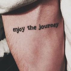 a person with a tattoo that says enjoy the journey