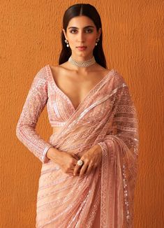 Featuring a rose pink embellished net saree with sequins, pearls and crystals work all over. Paired with a sweetheart deep neckline full sleeved blouse with sequins and pearl embellishments in set pattern along with the tassel tie-up at the back. Composition : Saree: Net, Blouse: Georgette Care: Dry Clean Only and Vacuum Storage All products can be customised for sleeves, length of blouse and neck design Delivery : 4-6 weeks as the product is hand crafted. Check Size Guide or choose MySize for free customisation (All Sizes above XL can be made at 15% additional cost) For more information and sizes please contact fabiliciousfashion@gmail.com or visit our Copenhagen studio.About the Designer : Angad Singh's journey in the world of fashion started with at an early age as he grew up in a famil Saree Net, Net Blouse, Net Embroidery, Crystal Embroidery, Net Saree, Set Patterns, Pattern Embroidery, Blouse For Women, Deep Neckline