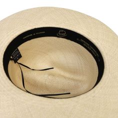 Handcrafted in Ecuador Entirely handmade from natural toquilla straw Provides protection from UV rays Beige Crown: 4 1/2" Brim: 6-7 cm Adjustable sweatband Ribbon: 1 3/8" Unisex Straw Cowboy Hat, Uv Rays, Black Ribbon, Fedora Hat, Hat Sizes, Classic Black, Fedora, Cowboy Hats, Timeless Elegance