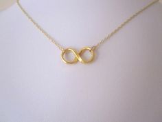 Small INFINITY ETERNITY LOVE in yellow gold plated sterling silver necklace. The Infinity pendant measures 9mm x 20mm Please choose length of the necklace from the drop-down menu.  Lead and nickel free necklace. The necklace comes bubble wrapped and gift wrapped in a complementary organza bag. Gold Infinity Necklace For Mother's Day, Minimalist Gold Infinity Necklace, Minimalist Infinity Gold Necklace, Dainty Gold Infinity Necklace, Symbolic Gold Infinity Jewelry, Symbolic Infinity-shaped Gold Jewelry, Symbolic Infinity Gold Jewelry, Gold Infinity Necklace For Gift, Infinity Pendant