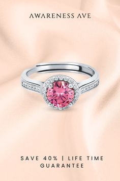 Discover 'The Venus', a captivating pink Moissanite ring that embodies romance. Its S925 sterling silver and exquisite platinum finish promise a lifetime of shine. Perfect for that heartfelt proposal or as a statement of self-love. #PinkRing #EngagementRing #MoissaniteElegance Pink Diamond Promise Ring With Halo Design, Pink Diamond Ring With Halo Design, Pink Moissanite Jewelry With Prong Setting, Pink Halo Ring With Round Setting, Pink Round Rings With Halo Setting, Pink Halo Setting Round Ring, Pink Round Halo Ring, Pink Diamond Ring With Halo Design For Anniversary, Pink Round Diamond Ring, Fine Jewelry