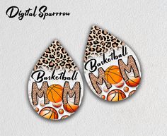 two earrings with the words basketball mom and an image of a leopard print on them