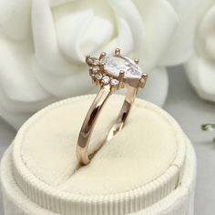 This beautiful ring is made from genuine 925 sterling silver with Rose Gold plating. Ring details- -The Main stone is a pear shape 9mm by 6mm Simulated Diamond -Side stones are Round Clear 1.5mm And 3mm by 2mm Pear Shape simulated diamonds -Ring is cast in solid 925 sterling silver with White Rose Gold plating ( Yellow Gold And White Rhodium plated also available, please check the drop down menu for more options) -The Total face height of the ring measures 12mms and the band width measures 2.2mm Simulated Diamond Rings, Diamond Crown, Fire Opal Ring, Etsy Wedding Rings, Engagement Wedding Ring, Diamonds Ring, Garnet Rings, Beautiful Ring, Color Ring