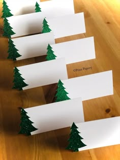 christmas tree place cards on a wooden table