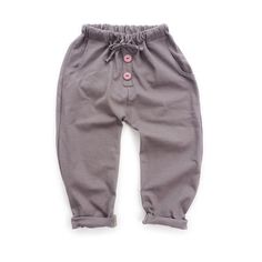 a baby's gray pants with buttons on the bottom and side, sitting against a white background