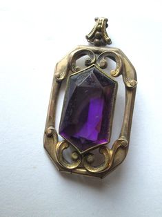 Beautiful Antique 1800s brass Art Nouveau pendant with a large purple glass stone in good Antique condition and measures 1 3/4 inches by 1 inch. Antique Engraved Purple Jewelry, Antique Purple Pendant Necklace, Antique Purple Collectible Jewelry, Antique Amethyst Pendant Jewelry, Vintage Amethyst Pendant Jewelry, Antique Purple Gemstone Jewelry, 1800s Art, Cuyahoga Falls, Art Nouveau Pendant