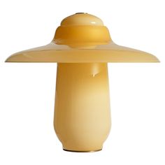 a yellow lamp that is on top of a table