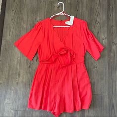 New With Tags Red Romper With Scalloped Detail, Tie For Waist Casual Red V-neck Jumpsuits And Rompers, Casual Red V-neck Jumpsuit, Red V-neck Jumpsuits And Rompers For Spring, Red V-neck Jumpsuit For Spring, Chic Red Short Sleeve Jumpsuits And Rompers, Red Jumpsuits And Rompers For Summer Workwear, Red Jumpsuits And Rompers For Day Out, Red Fitted Jumpsuits For Day Out, Light Blue Romper