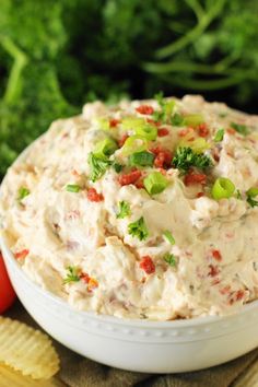 a white bowl filled with potato salad and broccoli