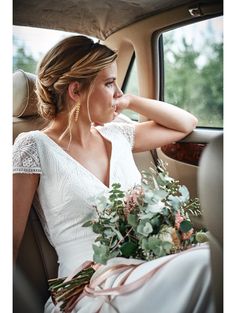 a woman sitting in the back seat of a car