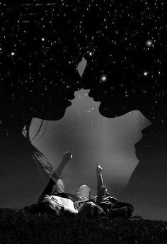 two people are laying on the ground under some trees at night with stars in the sky