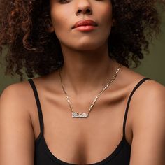 Our popular Double Plated Iced Out Script Name Necklace boasts a chic and elegant design, handcrafted to perfection. The model showcases the necklace with an 18-inch Cuban chain (see image for reference). Chain width:Cuban Chain - 3.7 mmFigaro Chain - 3 mmRope Chain - 2.3 mm Closure: All chains are fitted with a lobster clasp. Metal Selection: Gold Plated Silver Plated Sterling silver 14k gold plated over sterling silver 14k solid gold - (NAMEPLATE ONLY) Elegant Personalized Cuban Link Chain Necklace, Elegant Personalized Chain Link Necklaces, Elegant Personalized Chain Link Necklace, Adjustable Nameplate Chain Necklace, Elegant Metal Name Necklace With Adjustable Chain, Elegant Name Necklace With Adjustable Chain, Sterling Silver Nameplate Necklace With Adjustable Chain, Metal Name Necklace With Adjustable Chain Pendant, Metal Pendant Name Necklace With Adjustable Chain