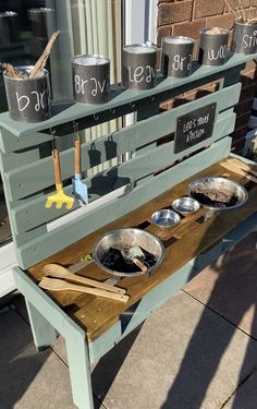 a bench that has bowls and pans on it