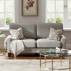 a living room scene with focus on the couch and coffee table in the foreground