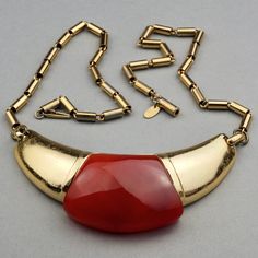 Features: - 100% Authentic LANVIN Paris. - Modernist necklace with orange lucite inset. - Gold tone hardware. - Some surface scratches on the metal part. - Tubular chain with some gold loss due to age. - Box clasp closure. - Signed LANVIN Paris on the oval tag next to the closure. - Good vintage condition. Measurement: Center Piece: 4 inches X 1.5 inches Chain: 20.5 inches **This necklace will be shipped via Priority Shipping with tracking number. Please convo me for any queries and additional p Luxury Vintage Orange Necklace, Luxury Modernist Necklace With Large Pendant, Vintage Orange Metal Necklaces, Luxury Modern Lucite Jewelry, Vintage Orange Metal Necklace, Luxury Gold Modernist Necklace, Collectible Modernist Pendant Necklace, Brass Necklace, Lanvin