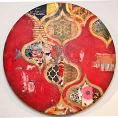 a red circular artwork with many different designs on it's sides and the bottom part of its surface