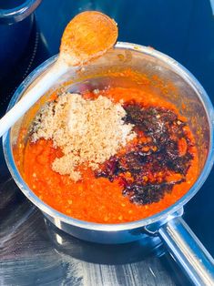 a pot filled with red sauce and spices