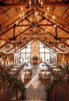 the inside of a large building with tables and chairs set up for an elegant dinner