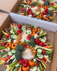 two boxes filled with different types of vegetables