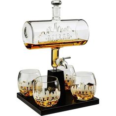 an old fashioned whiskey dispenser with four glasses on a black stand,