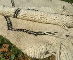 a white blanket laying on top of green grass