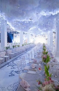 a banquet hall with tables and chairs set up for a formal function in the sky