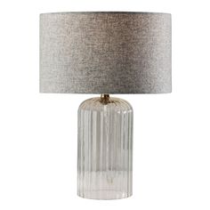 a clear glass table lamp with a grey shade on it's base and a silver drum light