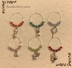 six wine glass charms in various colors and designs