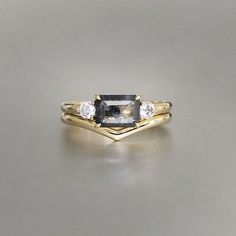 two gold rings with black and white diamonds