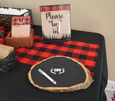 a black table topped with a red and black checkered table cloth next to boxes