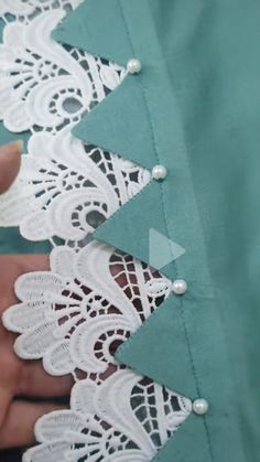 someone is cutting out the lace on a piece of fabric