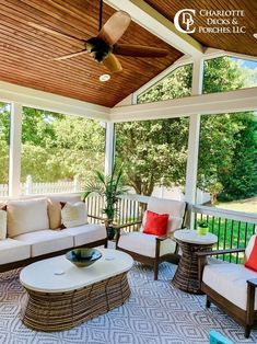 a covered porch with furniture and a ceiling fan