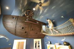 two pictures of a bedroom with a ship in the ceiling and other decorations on the walls