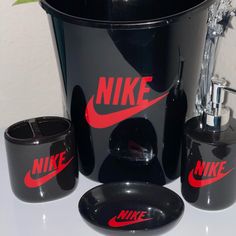 a black bathroom set with red nike logos on it