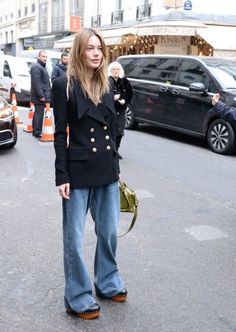 a woman standing in the middle of a street