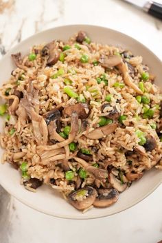 a white plate topped with rice and mushrooms