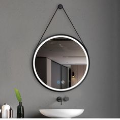 a bathroom mirror hanging on the wall above a sink