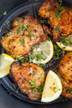 chicken thighs with lemons and parsley in a cast iron skillet