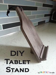 the diy table stand is made from wood and has a black cord attached to it