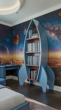 a room with a bed, desk and bookshelf in the shape of a rocket ship