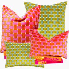 three colorful pillows sitting on top of each other