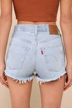 Warm weather is here and it's time to show off those sweet stems in the Levi's 501 Original Light Wash High Rise Cutoff Denim Shorts! Sturdy cotton denim (in Levi's Promise Me wash) shapes these cute shorts with a classic five-pocket cut, belt loops, a branded top button, and a hidden button fly. Subtle whiskering and heavily distressed details lend a lived-in aesthetic! Shredded, cut-off hems complete the look. Red logo tag and leather patch at back. Fit: This garment fits true to size. Length: Promise Me, Cycling Clothes, 90s Trends, Girl Fashion Style, Fashion Bottoms, Denim Cutoff Shorts, Denim Cutoffs, Levi's 501, Logo Tag