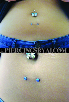 a woman's stomach with piercings on it