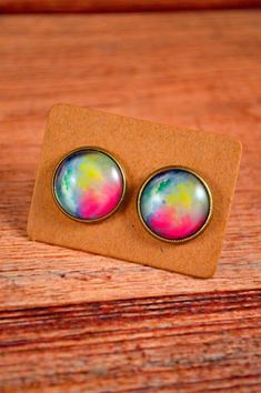 These pastel earrings are beautiful in color! These watercolor earrings are great for those who love the watercolor vibe, or enjoy the pastel look of the studs! They feature a rainbow pastel design, vibrant in color and a beautiful gift! These earrings measure about 12mm in diameter, or about half an inch. All studs come with a pair of rubber backings in order to secure the studs to your ears. All metals are antique bronze and hypoallergenic. All images are protected under a glass dome. Have any Watercolor Earrings, Pastel Jewelry, Galaxy Jewelry, Galaxy Earrings, Pastel Design, Pastel Earrings, Shiny Rings, Summer Rings, Mermaid Ring