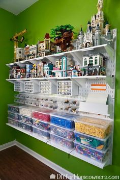 the lego display and storage wall is organized with plastic bins, shelves, and toys