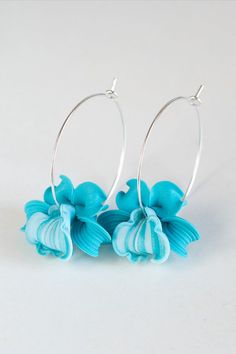 Pair of Hand Sculpted turquoise blue orchid Earrings hoops. Turquoise Flower in Hoops Earrings. Blue Handmade Flower Drop Earrings, Turquoise Nickel Free Flower Earrings, Nickel Free Turquoise Flower Earrings, Turquoise Dangle Earrings With Flower Charm, Blue Flower-shaped Hoop Earrings, Blue Flower Shaped Hoop Earrings, Blue Flower Hoop Earrings As Gift, Blue Flower Hoop Earrings Gift, Turquoise Flower-shaped Earrings With Flower Charm